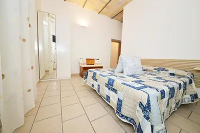a bedroom with a bed with a blue and white quilt at stars luxury apartments in Rome