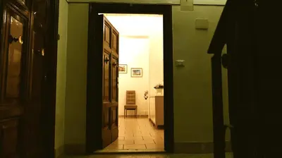 an open door to a hallway with a chair in a room at stars luxury apartments in Rome