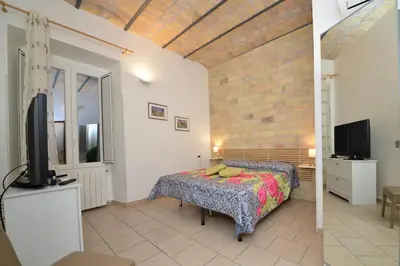 a bedroom with a bed and a tv in a room at stars luxury apartments in Rome