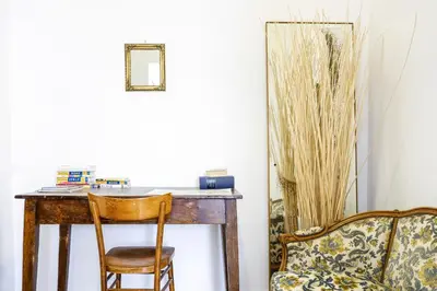 a desk with a chair next to a couch at Spacious Apartment with Big Terrace at Colosseum in Rome