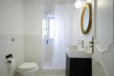 a bathroom with a toilet and a sink and a shower at Spacious Apartment with Big Terrace at Colosseum in Rome