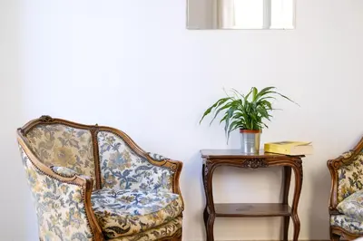 two chairs and a table with a potted plant at Spacious Apartment with Big Terrace at Colosseum in Rome