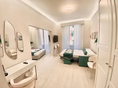 a hotel room with two beds and a bathroom at San Pietro Rooms 84 in Rome