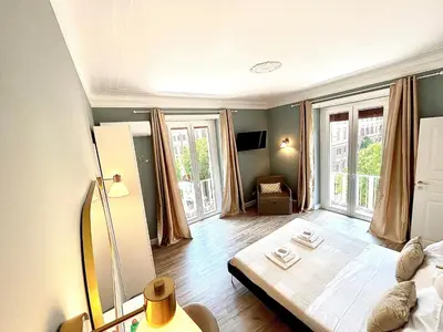 a living room with a bed and a large window at San Pietro Rooms 84 in Rome
