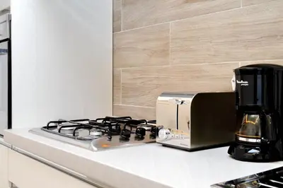 a kitchen counter with a stove and a coffee maker at La Finestra sul Vaticano in Rome