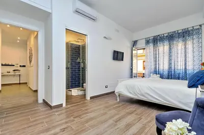 a bedroom with a large bed and a bathroom at La Finestra sul Vaticano in Rome
