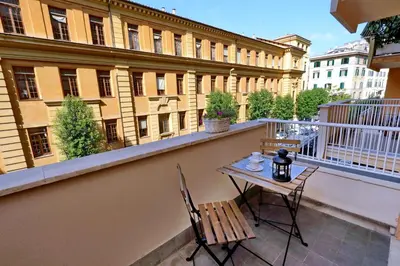 a balcony with a table and chairs and a building at La Finestra sul Vaticano in Rome