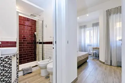 a bathroom with a toilet and a sink and a tub at La Finestra sul Vaticano in Rome