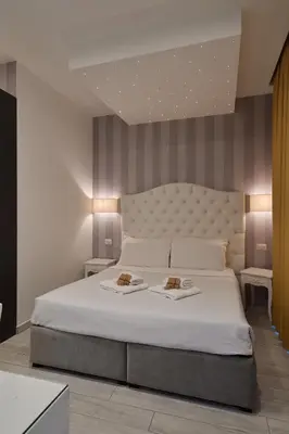 a bedroom with a bed with two plates of food on it at Relais Vatican Secret in Rome