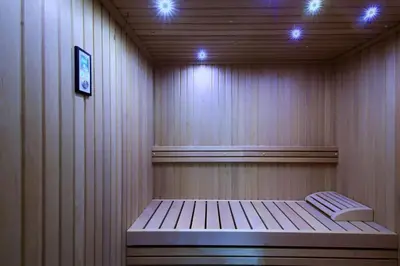 a sauna with a bench in a room with lights at Relais Vatican Secret in Rome