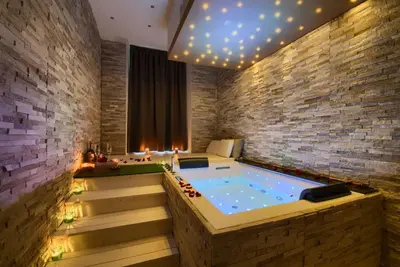 a jacuzzi tub in a room with a brick wall at Relais Vatican Secret in Rome