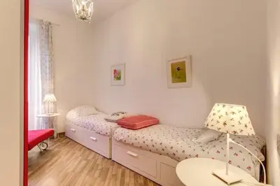 a bedroom with two twin beds and a table at Navona Flat di Elena & Paola in Rome