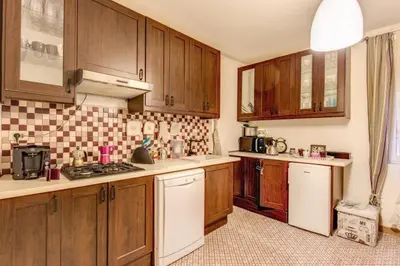 a kitchen with wooden cabinets and white appliances at Navona Flat di Elena & Paola in Rome