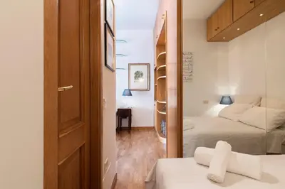 a bedroom with two beds and a door with a mirror at Lago Terrione Apartment - Charme Holidays in Rome