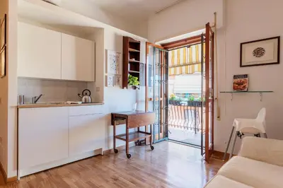 a kitchen with a desk and a table at Lago Terrione Apartment - Charme Holidays in Rome