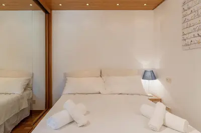 a bedroom with a white bed with two pillows at Lago Terrione Apartment - Charme Holidays in Rome