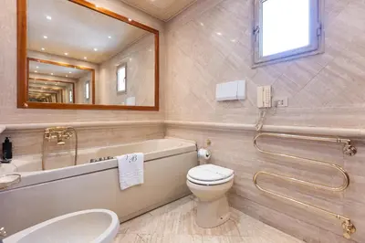 a bathroom with a tub and a toilet and a sink at Rental in Rome - Fontana Di Trevi Penthouse in Rome