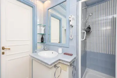 a bathroom with a sink and a mirror at Rental in Rome - Fontana Di Trevi Penthouse in Rome