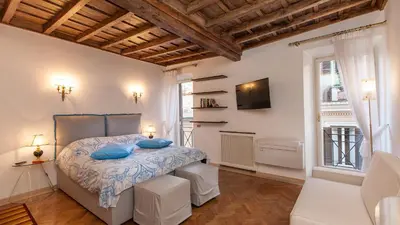 a bedroom with a bed with blue pillows on it at Rental in Rome - Gambero Suite in Rome