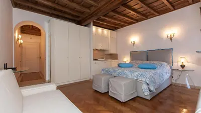 a bedroom with a bed with blue pillows on it at Rental in Rome - Gambero Suite in Rome