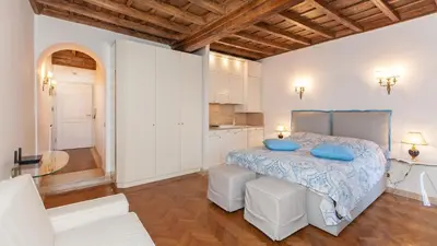 a bedroom with a bed with blue pillows on it at Rental in Rome - Gambero Suite in Rome