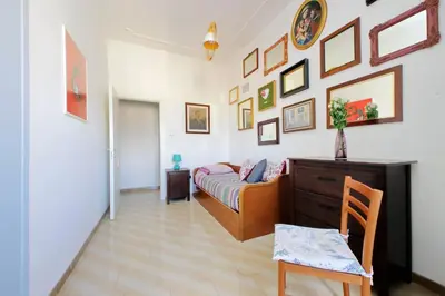 a bedroom with a bed and a table and a chair at Casa Rossi Roma in Rome