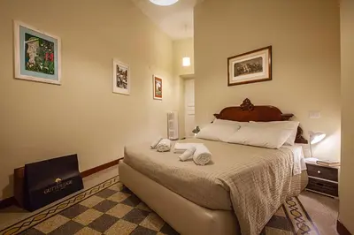 a bedroom with a large bed with towels on it at RomaAmor in Rome