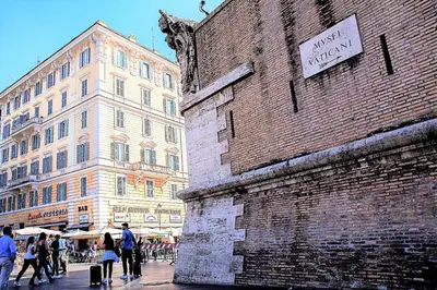 a group of people walking past a brick building at RomaAmor in Rome