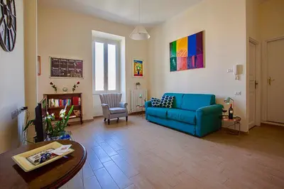 a living room with a blue couch and a table at RomaAmor in Rome