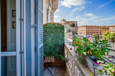 a balcony with plants and a bench on a building at RomaAmor in Rome