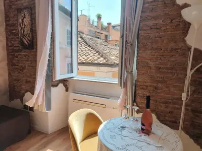 a room with a table and a large window at Marii Piazza Navona in Rome