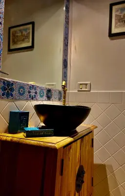 a bathroom with a black bowl sink on a counter at Moroni Trastevere Cozy Apartment in Rome