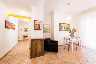 a living room with a table and a chair at Maison Velia San Giovanni in Rome