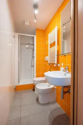 a bathroom with a white toilet and a sink at St Peter Rooms in Rome