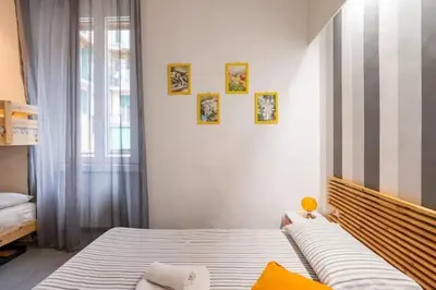 a bedroom with a bed and three pictures on the wall at St Peter Rooms in Rome