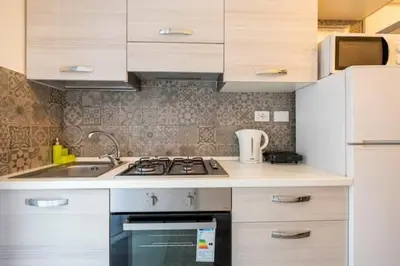 a kitchen with a sink and a stove top oven at St Peter Rooms in Rome