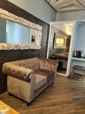a leather couch in a living room with a mirror at Spagna Boutique in Rome