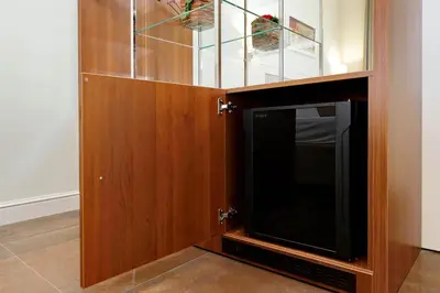 a wooden cabinet with a television inside of it at Piazza Venezia Grand Suite in Rome
