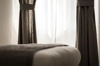 a close up of a bed in front of a window at Vinci House in Rome