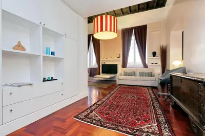 a living room with a couch and a rug at Pantheon Family Junior Suite in Rome