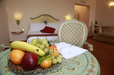 a plate of fruit on a table in a bedroom at Residenza Gens Julia in Rome
