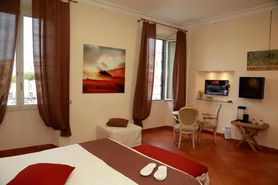 a hotel room with a bed and a living room at Residenza Gens Julia in Rome
