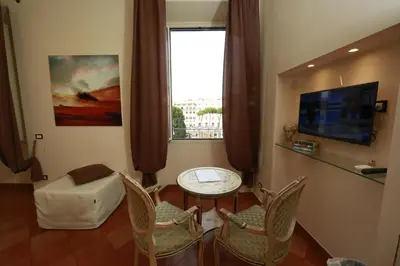 a living room with a table and chairs and a window at Residenza Gens Julia in Rome
