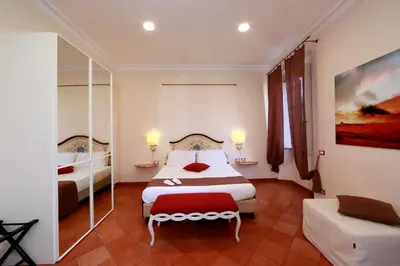 a hotel room with two beds and a couch at Residenza Gens Julia in Rome