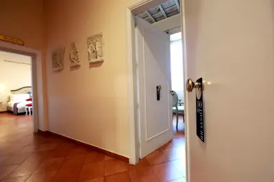 a hallway with a white door and a room at Residenza Gens Julia in Rome