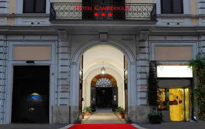 an entrance to a building with a red carpet at Hotel Campidoglio in Rome