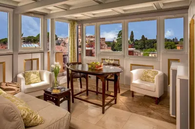 a living room with a table and chairs and windows at Lf View in Rome