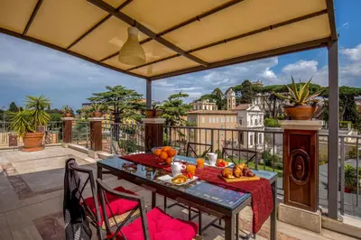 a table on a balcony with a view of the city at Lf View in Rome