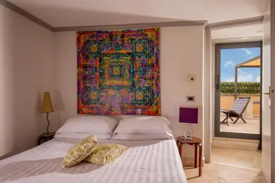 a bedroom with a bed with a painting on the wall at Lf View in Rome