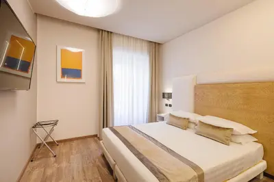 a bedroom with a bed and a television in it at Etruska luxury Trastevere Guesthouse in Rome
